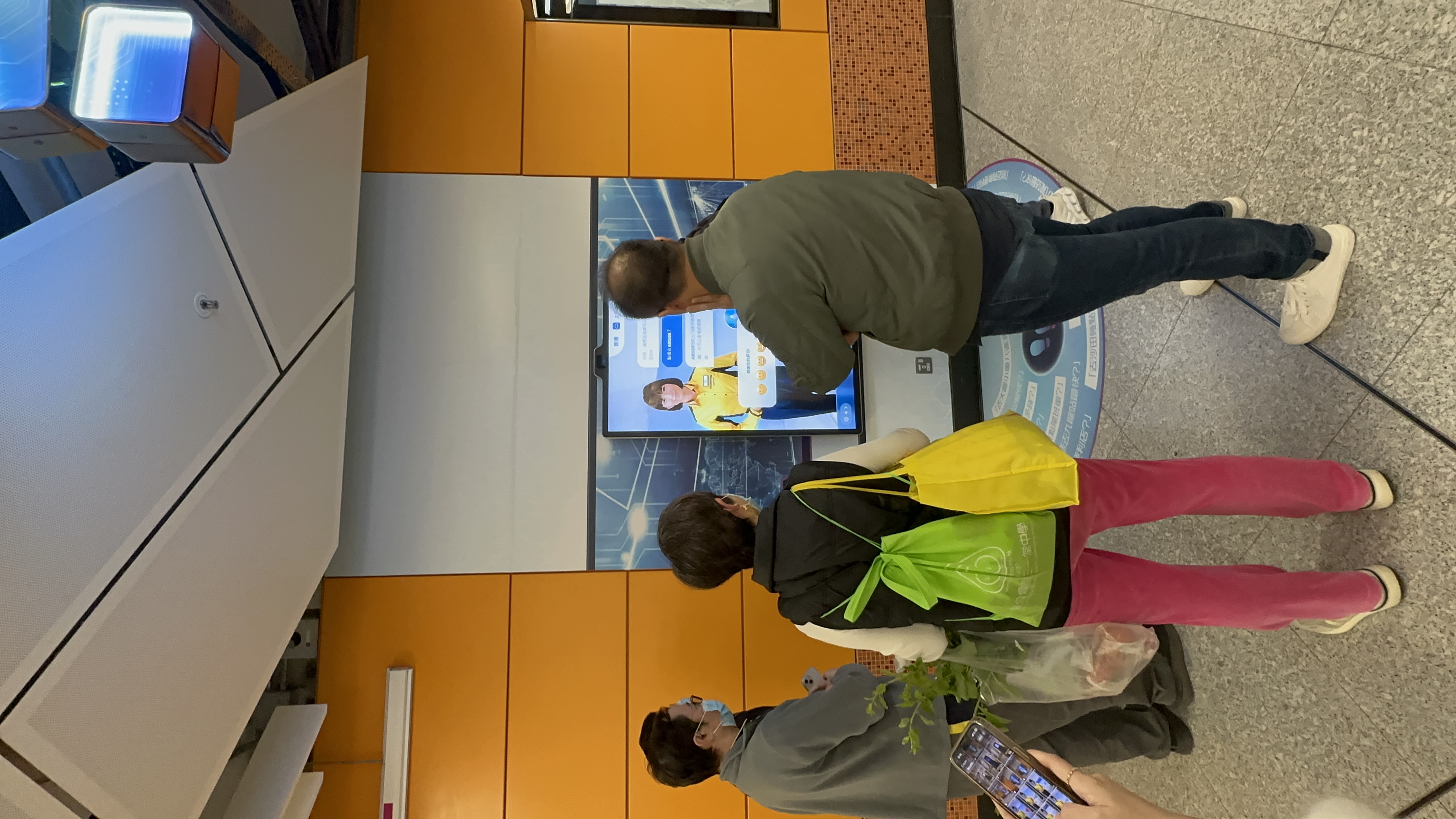 Passenger interacting with AI Tracy (paid area)